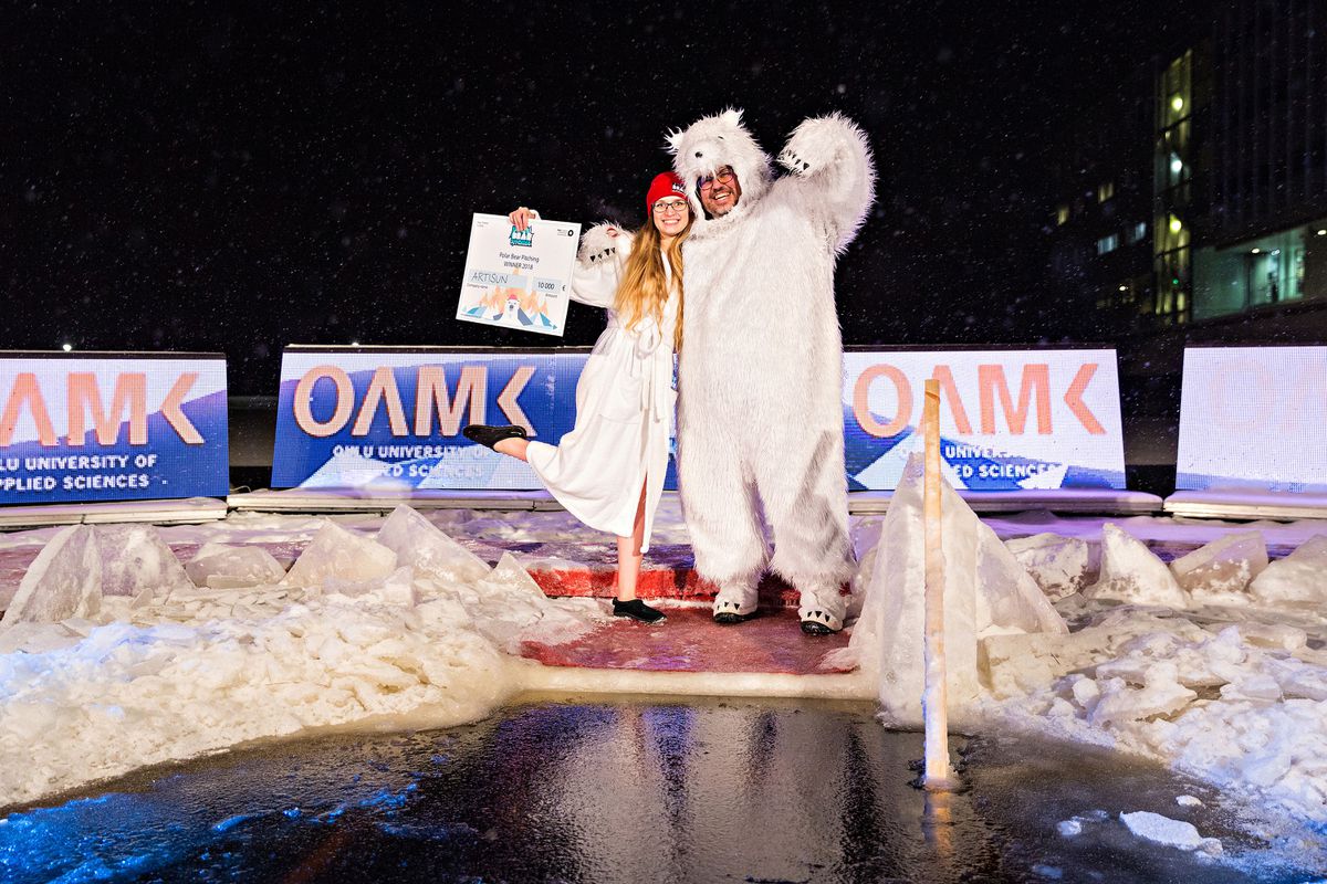 Artisun co-founder and CEO Tatsiana Zaretskaya gets a memory shot with J-Bear, the official Polar Bear Pitching mascot, played by American Jason Brower.